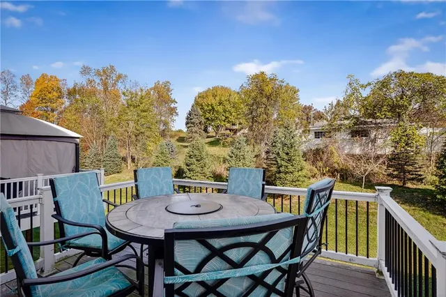 a view of a balcony with furniture and a potted plant