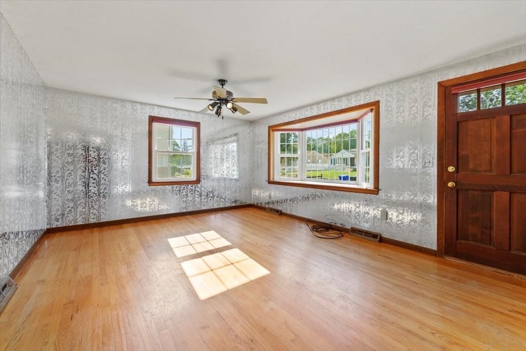 90 Fallston Street Springfield, MA 01119 - Photo 14 of 38 a view of an empty room with a window and wooden floor