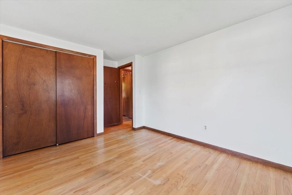 90 Fallston Street Springfield, MA 01119 - Photo 22 of 38 a view of an empty room with wooden floor and a window