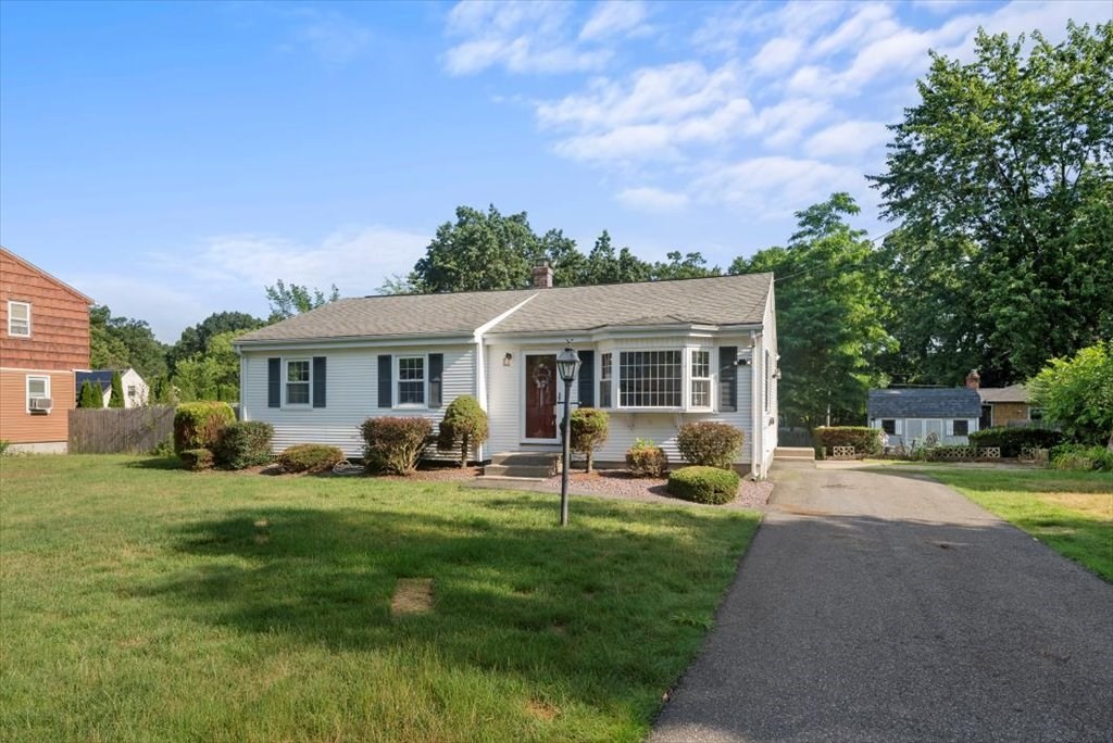 90 Fallston Street Springfield, MA 01119 - Photo 3 of 38 a front view of a house with a garden and trees