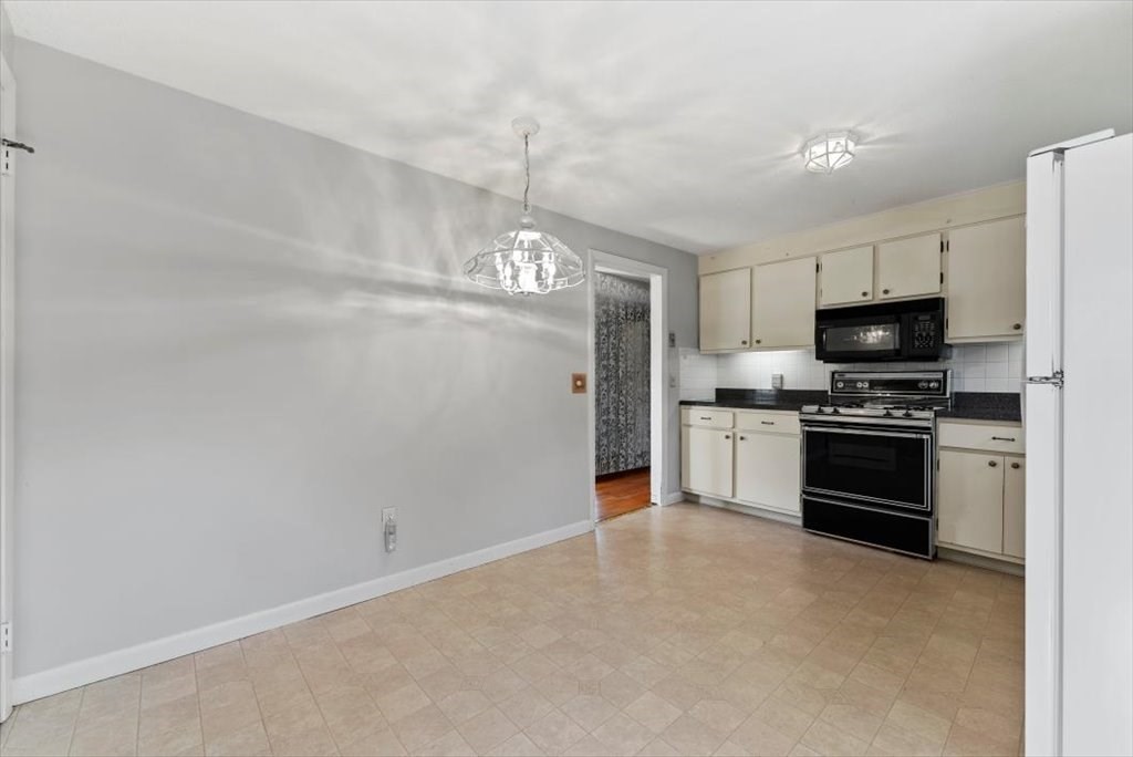 90 Fallston Street Springfield, MA 01119 - Photo 5 of 38 a kitchen with granite countertop a refrigerator oven a sink and dishwasher