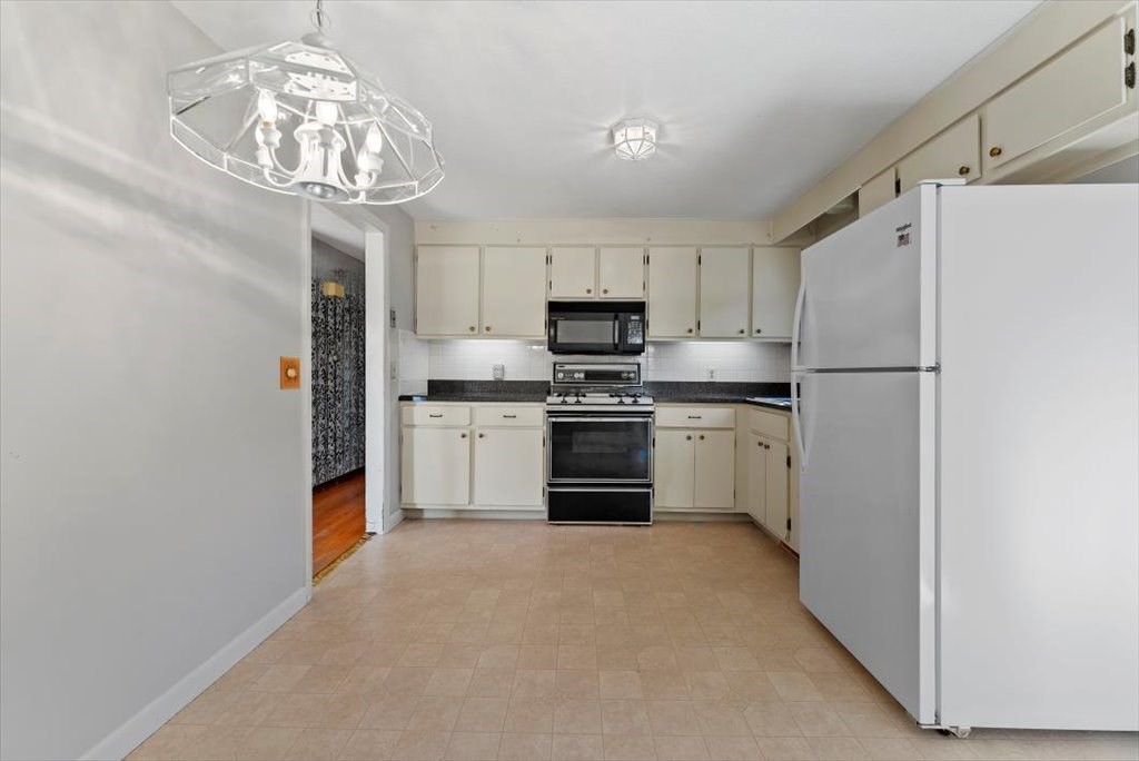90 Fallston Street Springfield, MA 01119 - Photo 6 of 38 a kitchen with stainless steel appliances a refrigerator sink and cabinets