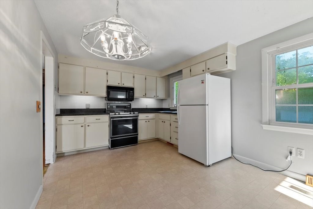 90 Fallston Street Springfield, MA 01119 - Photo 7 of 38 a kitchen with white cabinets and white appliances