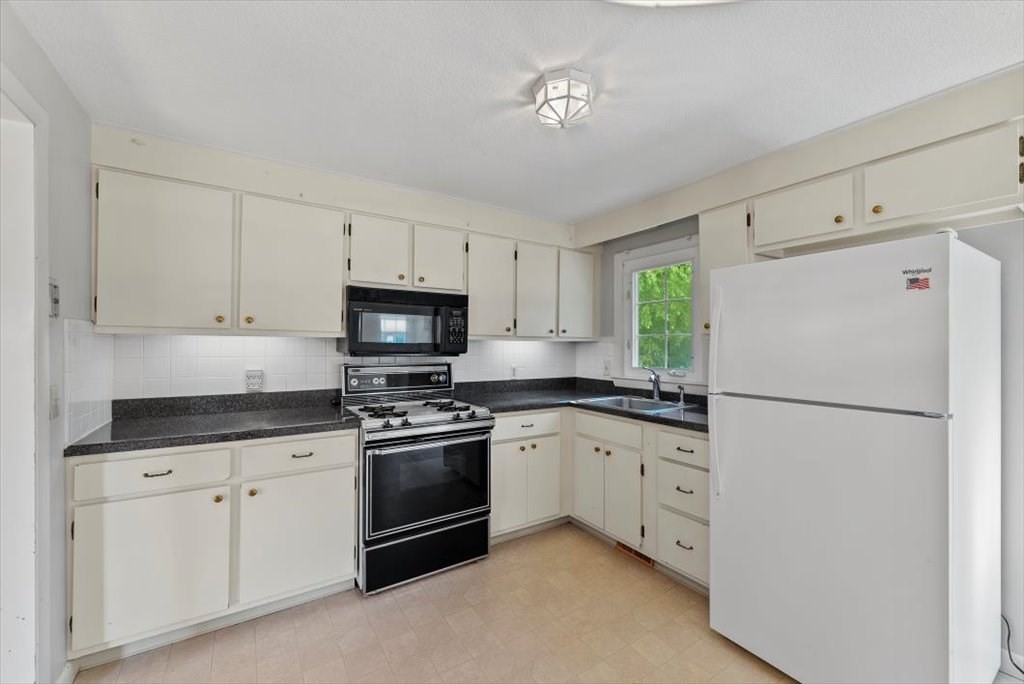 90 Fallston Street Springfield, MA 01119 - Photo 9 of 38 a kitchen with granite countertop cabinets appliances a sink and a window