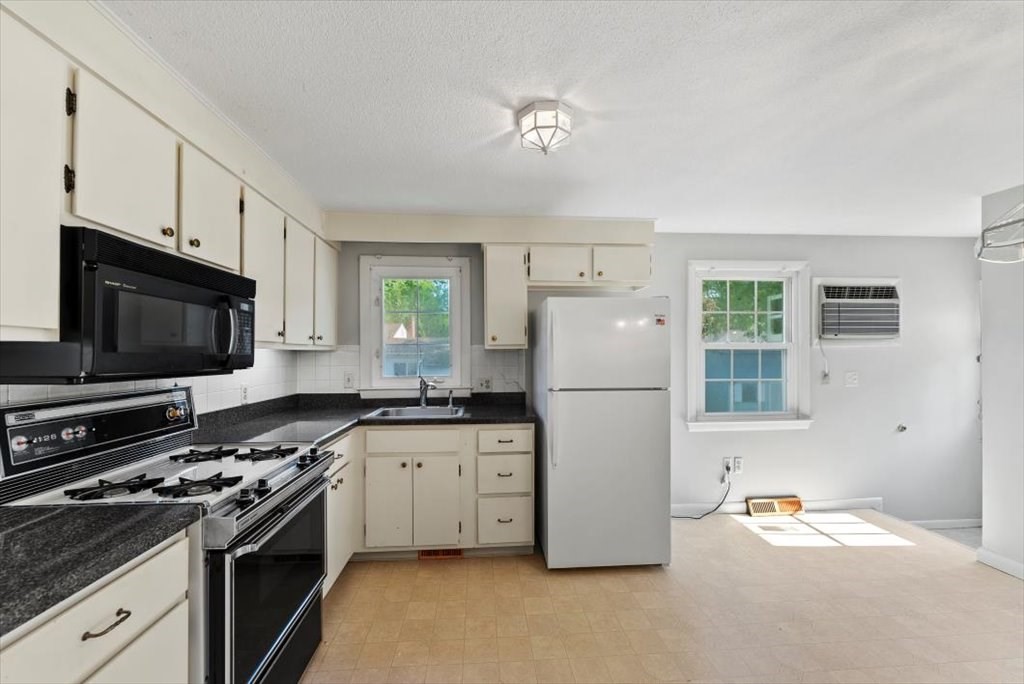 90 Fallston Street Springfield, MA 01119 - Photo 10 of 38 a kitchen with stainless steel appliances a refrigerator stove and microwave
