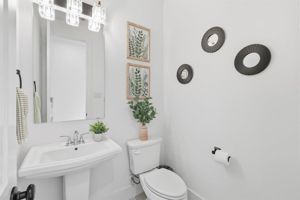4608 Mount Vista Road Oak Point, TX 75068 - Photo 8 of 39 Pedestal sink with chrome fixtures and a rectangular mirror
