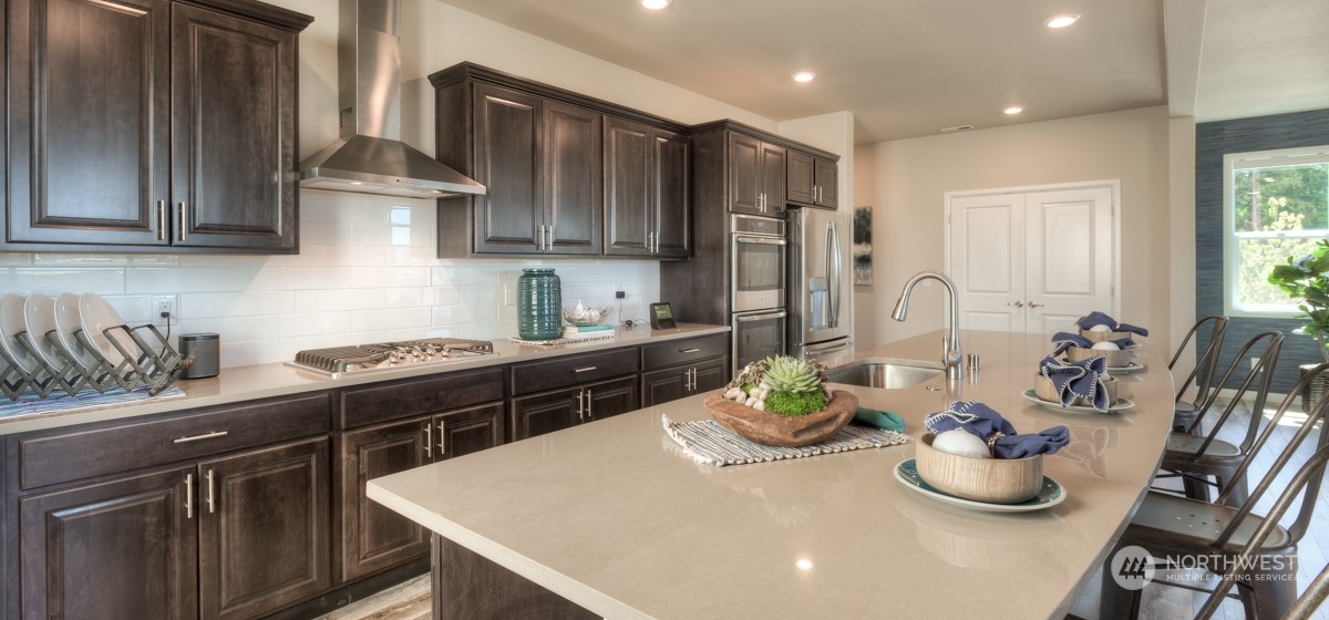 20926 42nd Drive Southeast, Unit 137 Bothell, WA 98021 - Photo 13 of 26 a kitchen with granite countertop a sink stove and cabinets