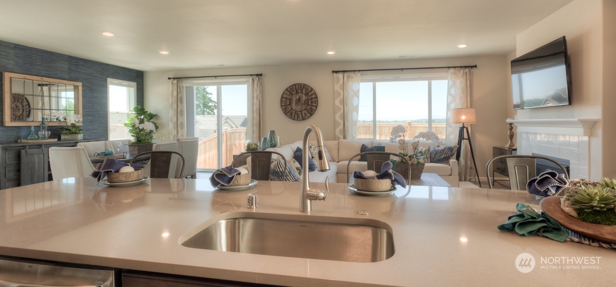 20926 42nd Drive Southeast, Unit 137 Bothell, WA 98021 - Photo 15 of 26 a kitchen with a sink a oven a dining table and chairs