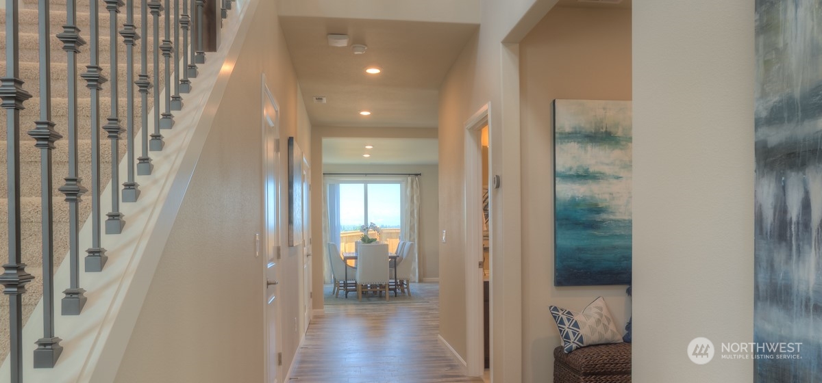 20926 42nd Drive Southeast, Unit 137 Bothell, WA 98021 - Photo 2 of 26 a view of a hallway with wooden floor and a bathroom
