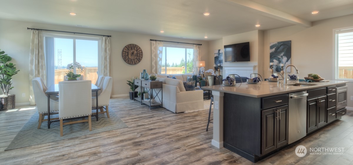 20926 42nd Drive Southeast, Unit 137 Bothell, WA 98021 - Photo 5 of 26 a living room with stainless steel appliances granite countertop furniture wooden floor and a view of kitchen