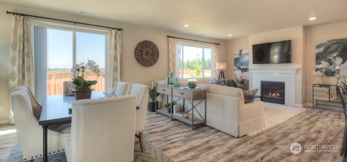20926 42nd Drive Southeast, Unit 137 Bothell, WA 98021 - Photo 7 of 26 a living room with furniture a large window and a fireplace