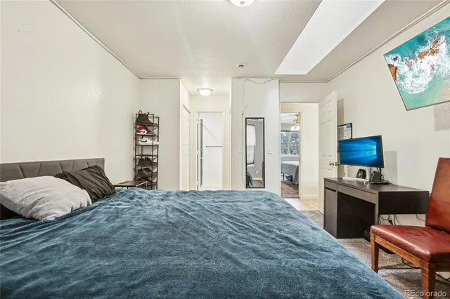 a bedroom with a bed window and a flat screen tv