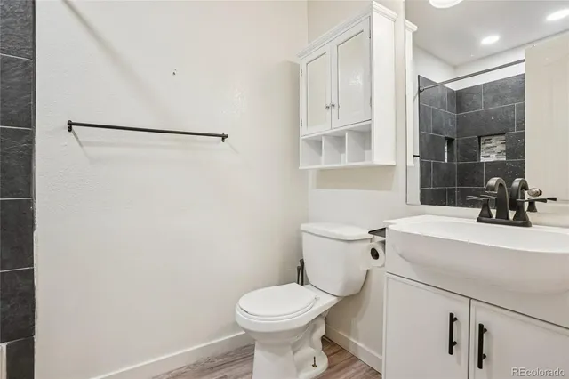 a bathroom with a sink toilet and shower