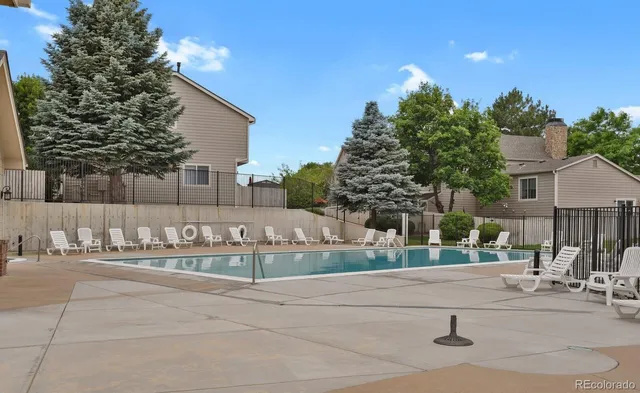 a front view of a house with a yard and table and chairs