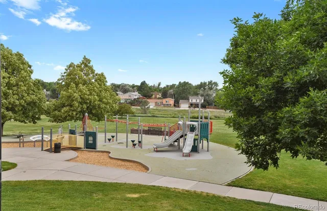a view of a backyard with plants and brick wall
