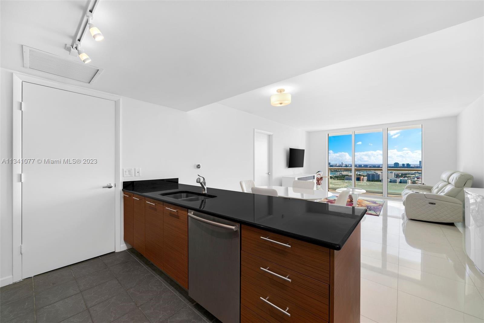 50 Biscayne Boulevard, Unit 3108 Miami, FL 33132 - Photo 1 of 26 a kitchen with granite countertop a sink and cabinets
