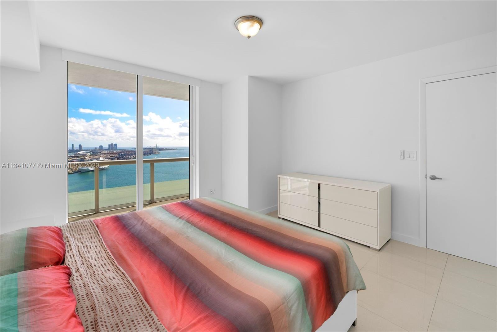 50 Biscayne Boulevard, Unit 3108 Miami, FL 33132 - Photo 16 of 26 a bedroom with a bed and a window
