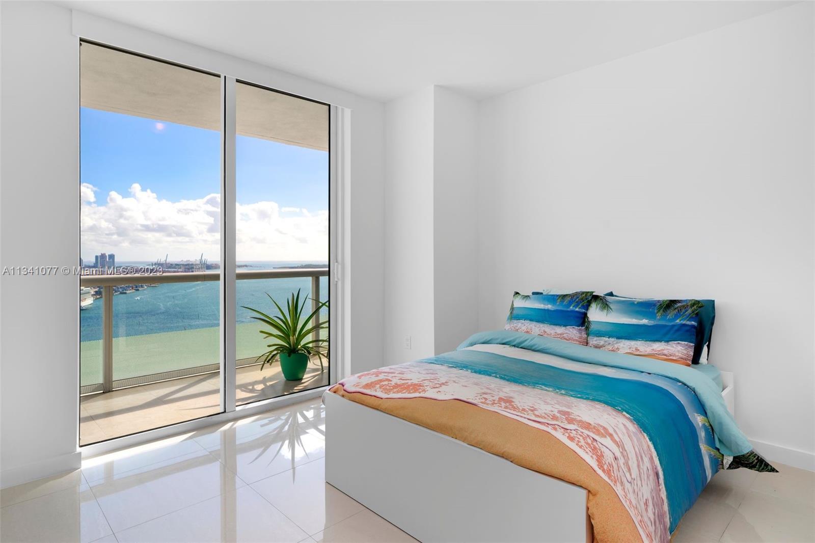 50 Biscayne Boulevard, Unit 3108 Miami, FL 33132 - Photo 19 of 26 a bedroom with a bed and a large window