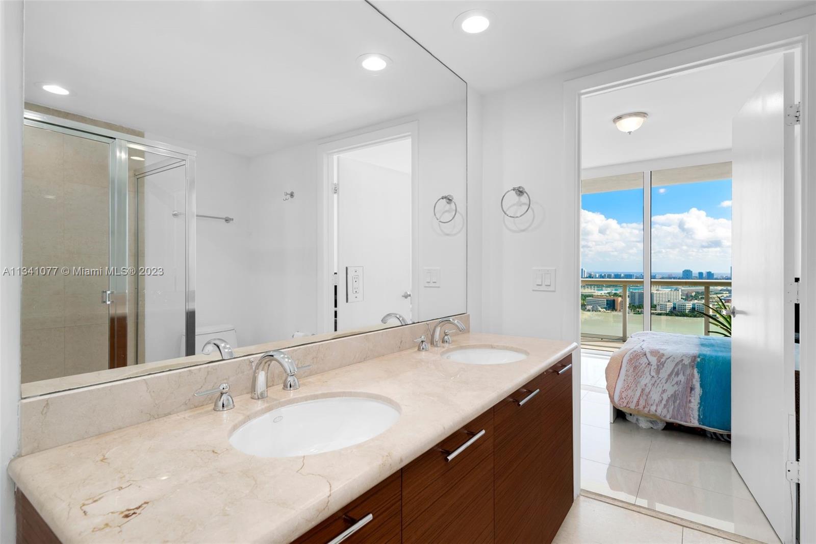50 Biscayne Boulevard, Unit 3108 Miami, FL 33132 - Photo 22 of 26 a en suite bathroom with a double vanity sink and mirror