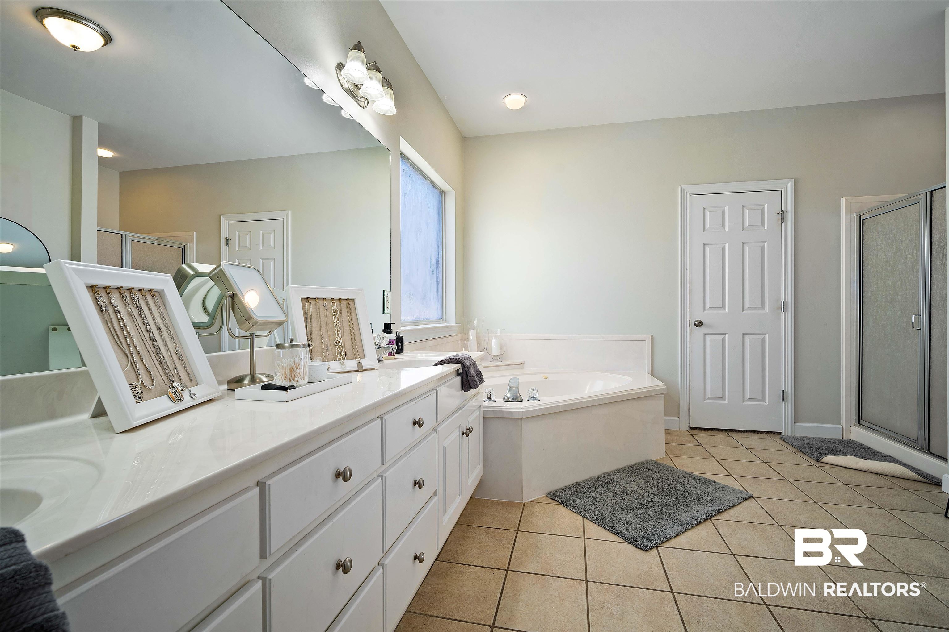 9552 White Castle Road Mobile, AL 36695 - Photo 18 of 31 Primary bathroom featuring double vanity, a shower stall, a jetted tub, and tile patterned floors