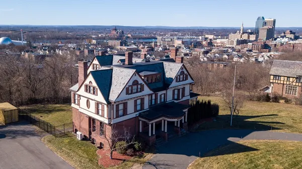 an aerial view of a house with backyard porch and furniture