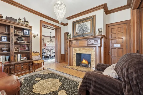 a living room with furniture fireplace and a window