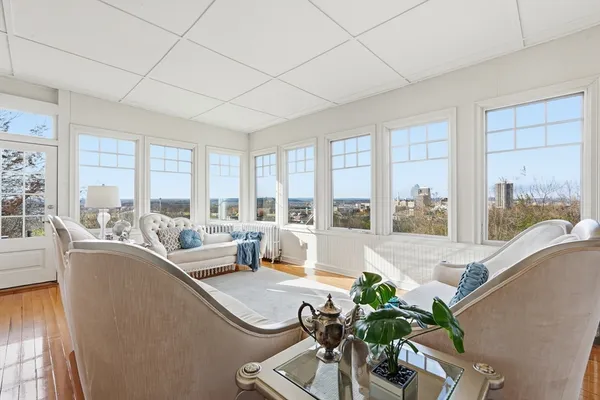 a living room with furniture and large windows