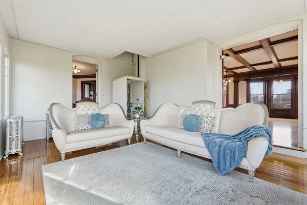 a living room with furniture a couch and wooden floor