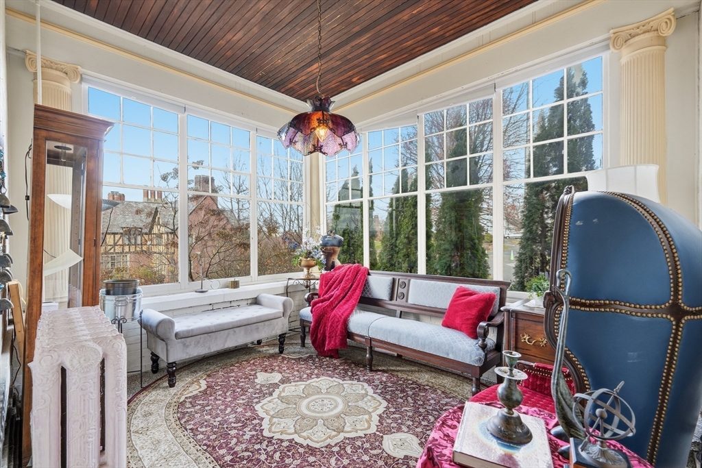 270 Maple Street Springfield, MA 01105 - Photo 16 of 42 a living room with furniture a rug and a chandelier