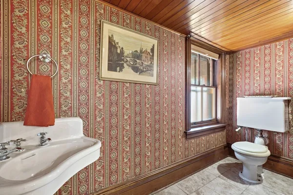 a bathroom with a toilet sink and mirror