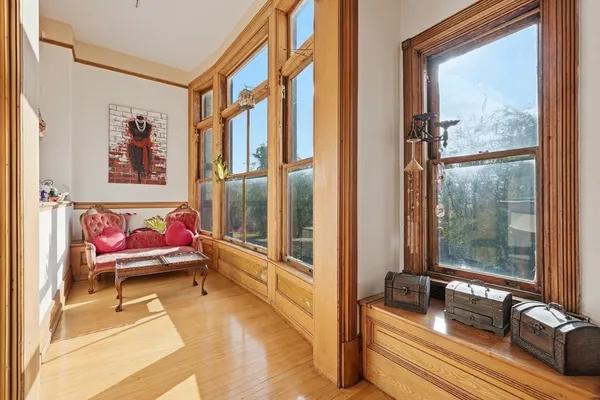 a living room with furniture and a floor to ceiling window