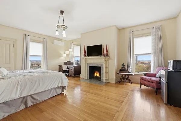 a spacious bedroom with a bed and a fireplace