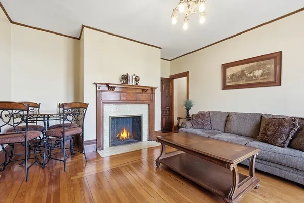 a living room with furniture a flat screen tv and a large window