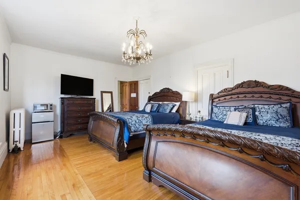 a bedroom with a large bed and dresser
