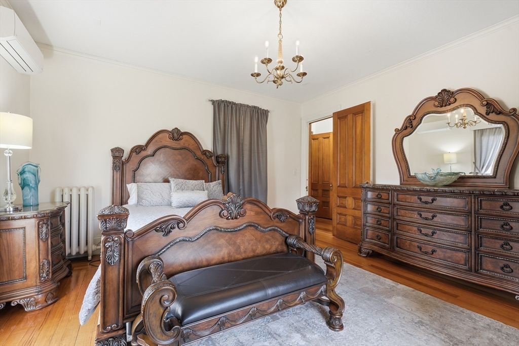 270 Maple Street Springfield, MA 01105 - Photo 34 of 42 a bedroom with a bed and wooden floor