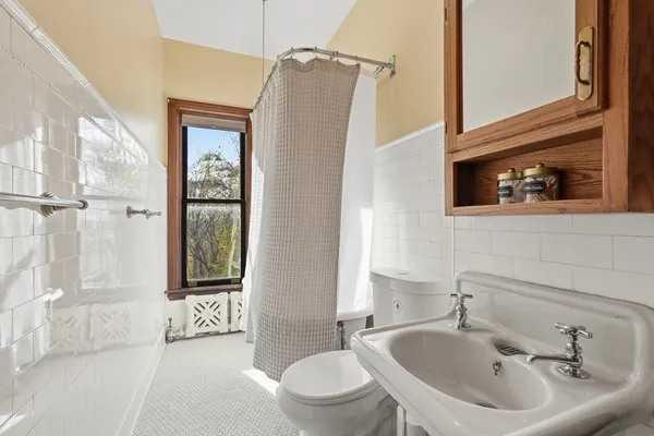a bed room with a bed window and a chair