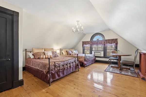 a bedroom with a large bed and a large window