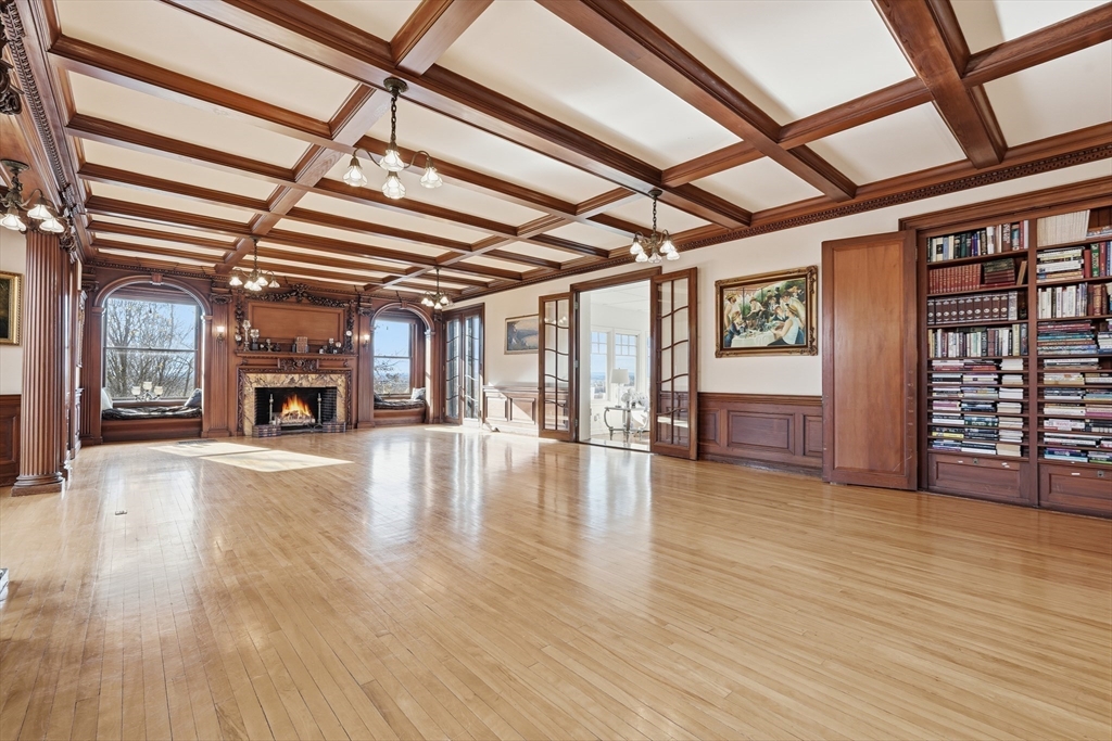 270 Maple Street Springfield, MA 01105 - Photo 6 of 42 a view of an empty room with wooden floor windows and a fireplace