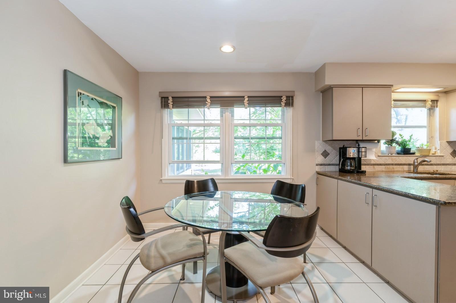 149 Parker Road South Plainsboro, NJ 08536 - Photo 30 of 57 a kitchen with a dining table chairs and a white refrigerator