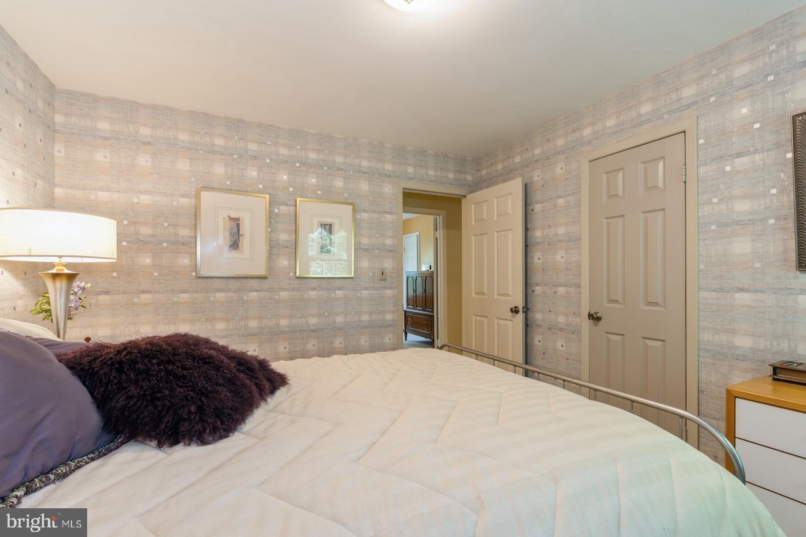 149 Parker Road South Plainsboro, NJ 08536 - Photo 43 of 57 a large bedroom with a bed a lamp and a large mirror