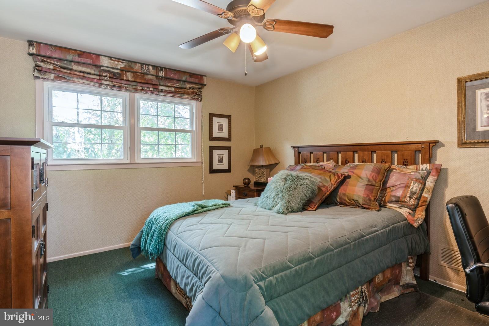 149 Parker Road South Plainsboro, NJ 08536 - Photo 45 of 57 a bedroom with a large bed and a chandelier