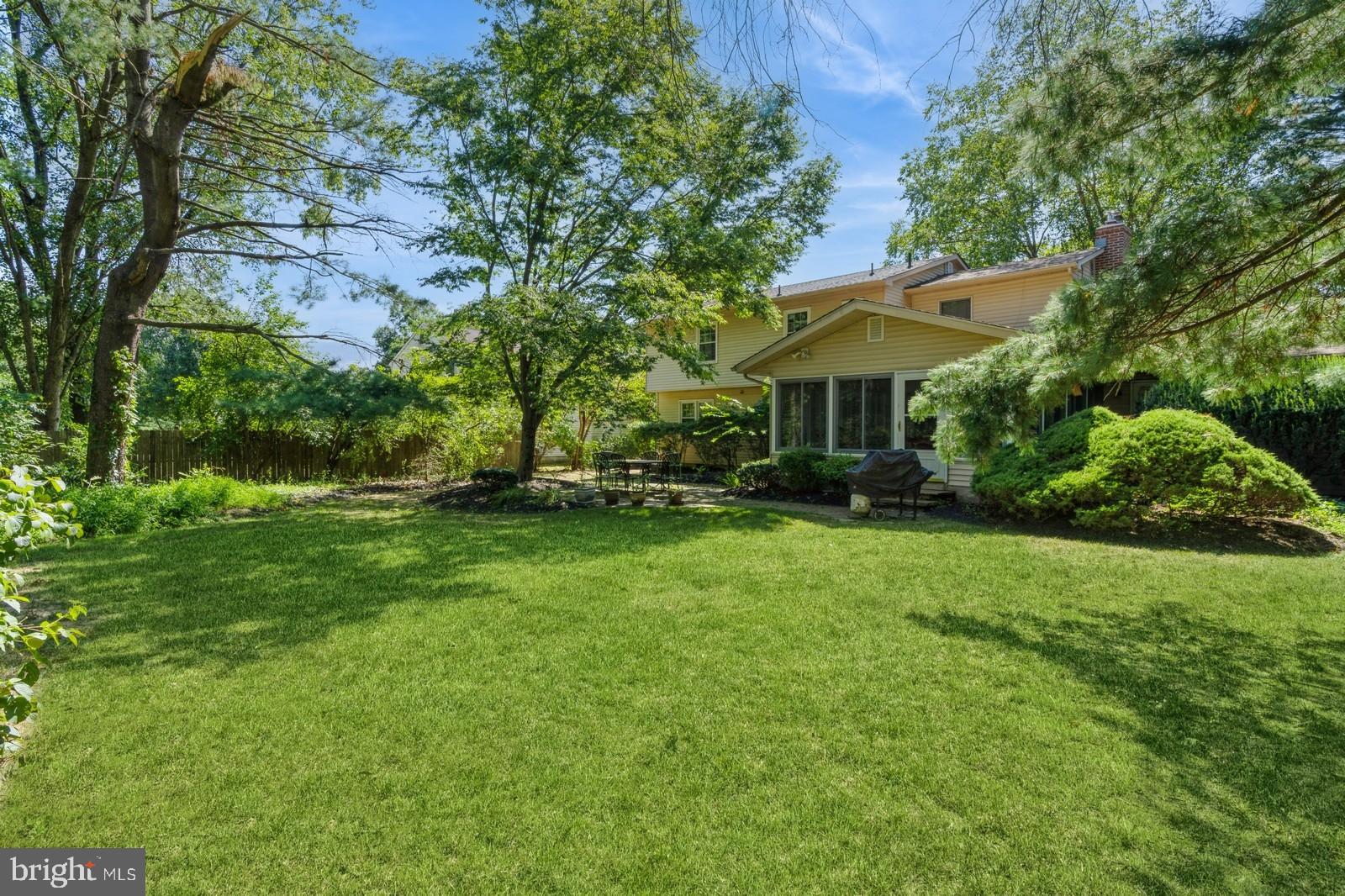 149 Parker Road South Plainsboro, NJ 08536 - Photo 53 of 57 a view of a patio with table and chairs under an umbrella