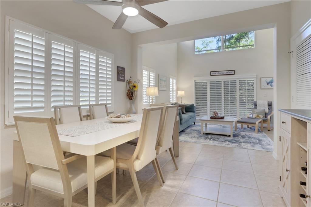 4500 Botanical Pl Circle, Unit 101 Naples, FL 34112 - Photo 11 of 44 a view of a dining room with furniture and a large window