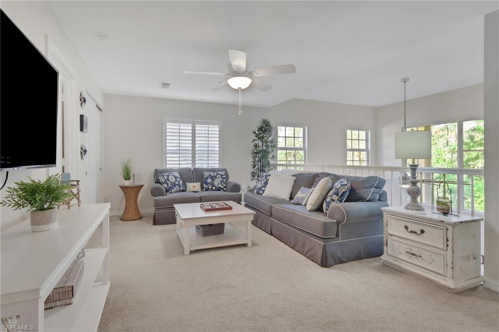 4500 Botanical Pl Circle, Unit 101 Naples, FL 34112 - Photo 13 of 44 a living room with furniture and a flat screen tv