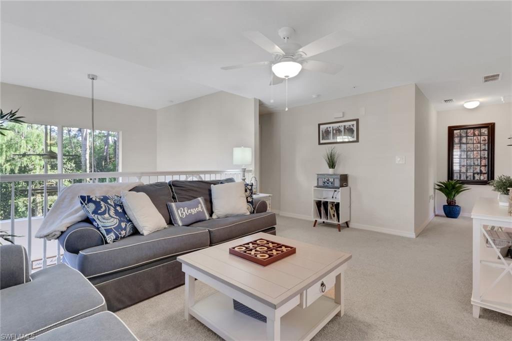4500 Botanical Pl Circle, Unit 101 Naples, FL 34112 - Photo 14 of 44 a living room with furniture and a wooden floor