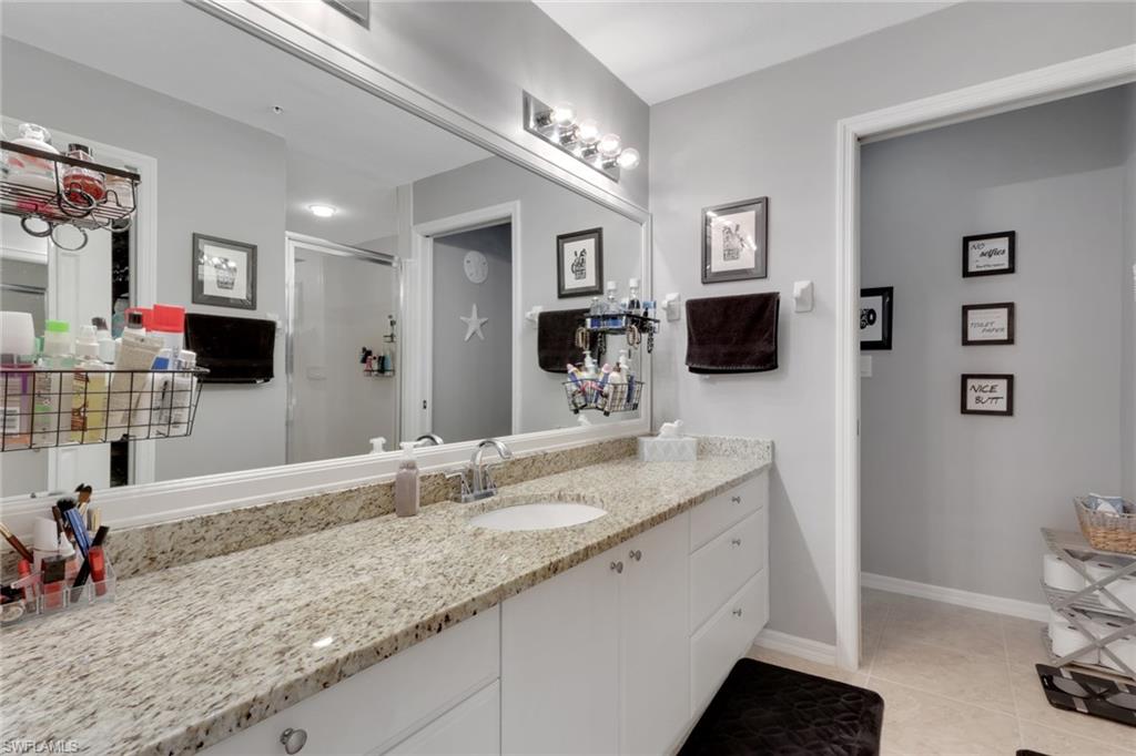 4500 Botanical Pl Circle, Unit 101 Naples, FL 34112 - Photo 18 of 44 a bathroom with double vanity and a sink