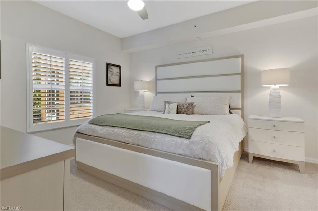 4500 Botanical Pl Circle, Unit 101 Naples, FL 34112 - Photo 20 of 44 a bedroom with a bed and a window