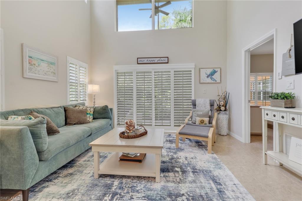 4500 Botanical Pl Circle, Unit 101 Naples, FL 34112 - Photo 3 of 44 a living room with furniture window and wooden floor