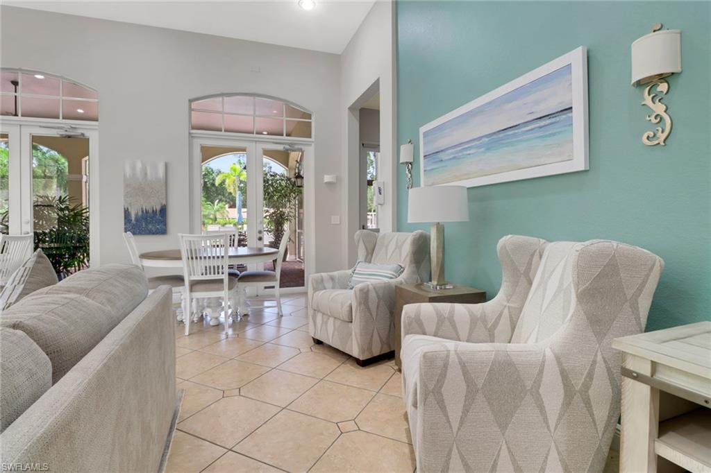 4500 Botanical Pl Circle, Unit 101 Naples, FL 34112 - Photo 31 of 44 a living room with furniture and a large window
