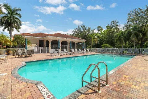 a view of a swimming pool with a table and chairs